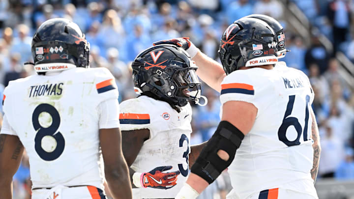 Oct 25, 2025; Chapel Hill, North Carolina, USA; Virginia Cavaliers running back J'Mari Taylor (3) celebrates with wide receiver Jayden Thomas (8) and center Drake Metcalf (60) after scoring a touchdown in overtime at Kenan Stadium. Mandatory Credit: Bob Donnan-Imagn Images Oct 25, 2025; Chapel Hill, North Carolina, USA; Virginia Cavaliers running back J'Mari Taylor (3) celebrates with wide receiver Jayden Thomas (8) and center Drake Metcalf (60) after scoring a touchdown in overtime at Kenan Stadium. Mandatory Credit: Bob Donnan-Imagn Images