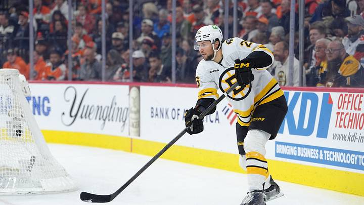 Apr 5, 2026; Philadelphia, Pennsylvania, USA; Boston Bruins defenseman Andrew Peeke (26) passes the puck against the Philadelphia Flyers in the first period at Xfinity Mobile Arena. Mandatory Credit: Kyle Ross-Imagn Images