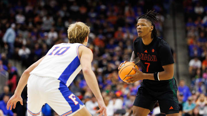 Nov 16, 2025; Gainesville, Florida, USA; Miami Hurricanes forward Shelton Henderson (7) looks to pass while Florida Gators forward Thomas Haugh (10) defends during the second half at VyStar Veterans Memorial Arena. Mandatory Credit: Matt Pendleton-Imagn Images
