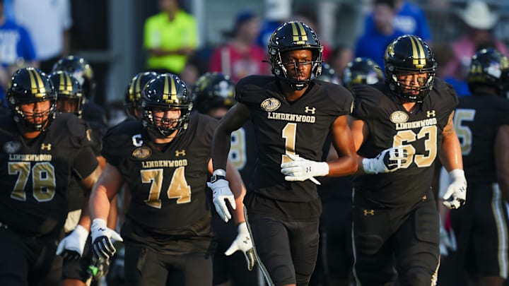 Aug 29, 2024; Kansas City, Kansas, USA; Lindenwood Lions wide receiver Jeff Caldwell (1) leads teammates onto the field during the first half against the Kansas Jayhawks at Children's Mercy Park. Mandatory Credit: Jay Biggerstaff-Imagn Images