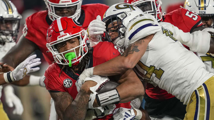 Nov 25, 2023; Atlanta, Georgia, USA; Georgia Bulldogs running back Kendall Milton (2) runs against Georgia Tech Yellow Jackets linebacker Kyle Efford (44) during the second half at Hyundai Field. Mandatory Credit: Dale Zanine-USA TODAY Sports Nov 25, 2023; Atlanta, Georgia, USA; Georgia Bulldogs running back Kendall Milton (2) runs against Georgia Tech Yellow Jackets linebacker Kyle Efford (44) during the second half at Hyundai Field. Mandatory Credit: Dale Zanine-USA TODAY Sports