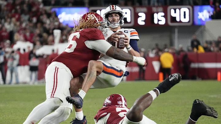 Nov 30, 2024; Tuscaloosa, Alabama, USA; Alabama Crimson Tide defensive lineman Tim Keenan III (96) hits Auburn Tigers quarterback Payton Thorne (1) for a loss during the second half at Bryant-Denny Stadium. Alabama won 28-14. Mandatory Credit: Gary Cosby Jr.-Imagn Images Nov 30, 2024; Tuscaloosa, Alabama, USA; Alabama Crimson Tide defensive lineman Tim Keenan III (96) hits Auburn Tigers quarterback Payton Thorne (1) for a loss during the second half at Bryant-Denny Stadium. Alabama won 28-14. Mandatory Credit: Gary Cosby Jr.-Imagn Images
