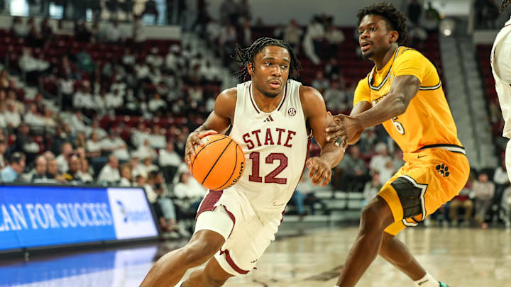 Feb 1, 2025; Starkville, Mississippi, USA; Mississippi State Bulldogs guard Josh Hubbard (12) drives to the basket against Missouri Tigers guard Annor Boateng (6) during the second half at Humphrey Coliseum. Mandatory Credit: Wesley Hale-Imagn Images