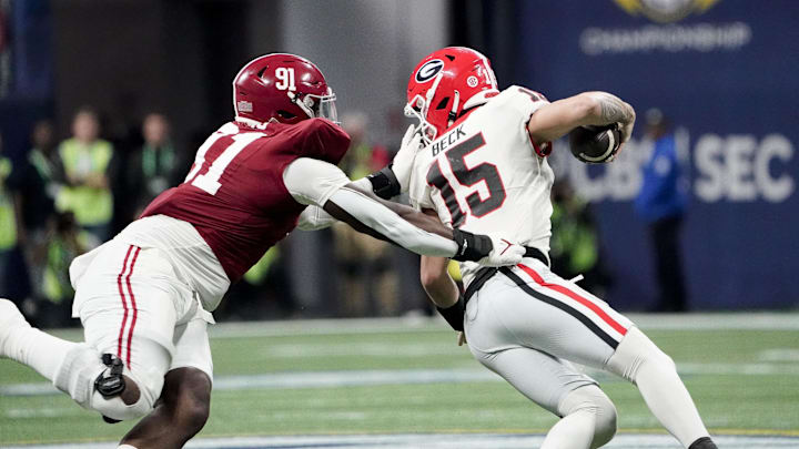 Dec 2, 2023; Atlanta, GA, USA;  Alabama Crimson Tide defensive lineman Jaheim Oatis (91) sacks Georgia Bulldogs quarterback Carson Beck (15) for a loss but was called for a face mask penalty at Mercedes-Benz Stadium. Alabama defeated Georgia 27-24 to claim the SEC Championship. Mandatory Credit: Gary Cosby Jr.-Imagn Images