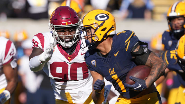 Oct 28, 2023; Berkeley, California, USA; USC Trojans defensive lineman Bear Alexander (90) reaches out to tackle California Golden Bears running back Jaydn Ott (1) during the third quarter at California Memorial Stadium. Mandatory Credit: Darren Yamashita-Imagn Images