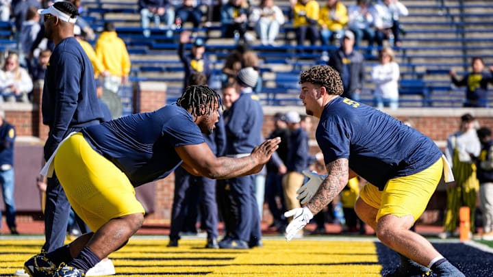 Michigan defensive lineman Kenneth Grant (78), left, warms up with defensive lineman Mason Graham (55) before the Oregon game at Michigan Stadium in Ann Arbor on Saturday, Nov. 2, 2024.