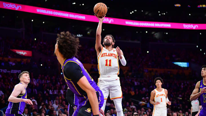 Jan 3, 2025; Los Angeles, California, USA; Atlanta Hawks guard Trae Young (11) shoots against Los Angeles Lakers center Jaxson Hayes (11) during the first half at Crypto.com Arena. Mandatory Credit: Gary A. Vasquez-Imagn Images