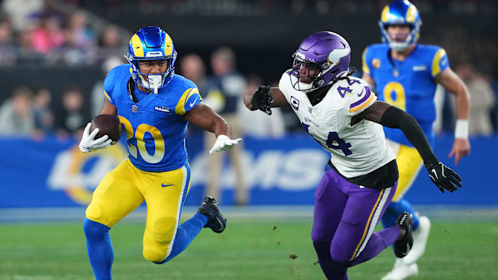 Jan 13, 2025; Glendale, AZ, USA; Los Angeles Rams running back Ronnie Rivers (20) rushes the ball against Minnesota Vikings safety Josh Metellus (44) during the second half in an NFC wild card game at State Farm Stadium. Mandatory Credit: Joe Camporeale-Imagn Images