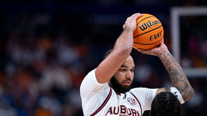 Auburn forward Johni Broome (4) pulls down a rebound against Tennessee forward Felix Okpara (34)during the first half of their semifinal game of the SEC Men's Basketball Tournament at Bridgestone Arena in Nashville, Tenn., Saturday, March 15, 2025.