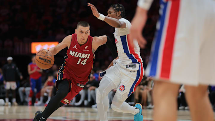 Mar 19, 2025; Miami, Florida, USA; Miami Heat guard Tyler Herro (14) drives to the basket  against Detroit Pistons forward Ausar Thompson (9) during the second quarter at Kaseya Center. Mandatory Credit: Sam Navarro-Imagn Images