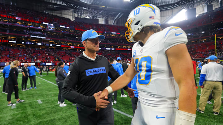 Dec 1, 2024; Atlanta, Georgia, USA; Los Angeles Chargers head coach Jim Harbaugh talks to quarterback Justin Herbert (10) after a victory over the Atlanta Falcons at Mercedes-Benz Stadium. Mandatory Credit: Brett Davis-Imagn Images