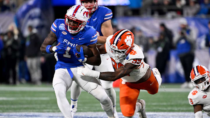 Dec 7, 2024; Charlotte, NC, USA; DUPLICATE***Southern Methodist Mustangs running back Brashard Smith (1) runs against Clemson Tigers defensive end A.J. Hoffler (99) during the first quarter in the 2024 ACC Championship game at Bank of America Stadium. Mandatory Credit: Bob Donnan-Imagn Images