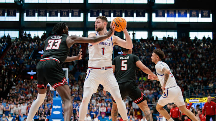 Mar 1, 2025; Lawrence, Kansas, USA; Kansas Jayhawks center Hunter Dickinson (1) sets the play around Texas Tech Red Raiders forward Federiko Federiko (33) during the second half at Allen Fieldhouse. Mandatory Credit: William Purnell-Imagn Images