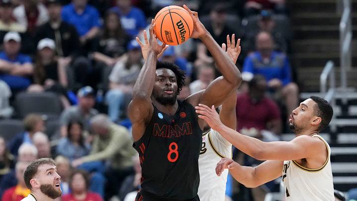 Miami Hurricanes center Ernest Udeh Jr. (8) looks to pass the ball while being defended by Purdue Boilermakers guard Braden Smith (3) and forward Trey Kaufman-Renn (4) during a NCAA Tournament second round game Sunday, March 22, 2026, at Enterprise Center in St. Louis. Purdue defeated Miami 79-69. Miami Hurricanes center Ernest Udeh Jr. (8) looks to pass the ball while being defended by Purdue Boilermakers guard Braden Smith (3) and forward Trey Kaufman-Renn (4) during a NCAA Tournament second round game Sunday, March 22, 2026, at Enterprise Center in St. Louis. Purdue defeated Miami 79-69.