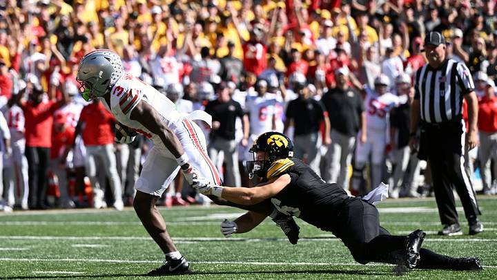 Oct 3, 2026; Iowa City, Iowa, USA; Ohio State Buckeyes wide receiver Devin McCuin (3) runs to score a touchdown against Iowa Hawkeyes defensive back Zach Lutmer (6) during the first half at Kinnick Stadium. Mandatory Credit: Jeffrey Becker-Imagn Images Oct 3, 2026; Iowa City, Iowa, USA; Ohio State Buckeyes wide receiver Devin McCuin (3) runs to score a touchdown against Iowa Hawkeyes defensive back Zach Lutmer (6) during the first half at Kinnick Stadium. Mandatory Credit: Jeffrey Becker-Imagn Images