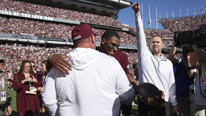Texas A&M Aggies quarterback Marcel Reed embraces head coach Mike Elko after the game against the South Carolina Gamecocks at Kyle Field. Texas A&M Aggies quarterback Marcel Reed embraces head coach Mike Elko after the game against the South Carolina Gamecocks at Kyle Field.