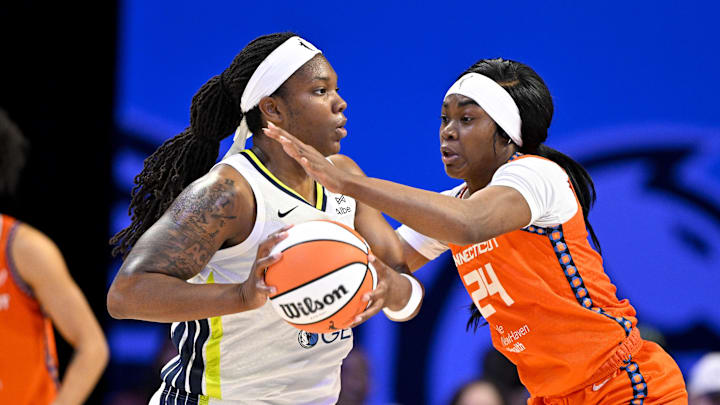Dallas Wings forward Myisha Hines-Allen looks to move the ball past Connecticut Sun forward Aneesah Morrow.