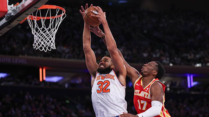 Jan 20, 2025; New York, New York, USA; New York Knicks center Karl-Anthony Towns (32) rebounds against Atlanta Hawks forward Onyeka Okongwu (17) during the second half at Madison Square Garden. Mandatory Credit: Vincent Carchietta-Imagn Images