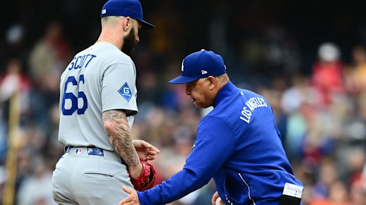 May 28, 2025; Cleveland, Ohio, USA; Los Angeles Dodgers manager Dave Roberts (30) relieves relief pitcher Tanner Scott (66) during the eighth inning against the Cleveland Guardians at Progressive Field. Mandatory Credit: Ken Blaze-Imagn Images