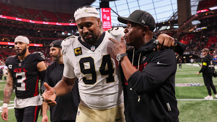 Jan 4, 2026; Atlanta, Georgia, USA; New Orleans Saints defensive end Cameron Jordan (94) walks with Atlanta Falcons head coach Raheem Morris after a game at Mercedes-Benz Stadium. Mandatory Credit: Brett Davis-Imagn Images
