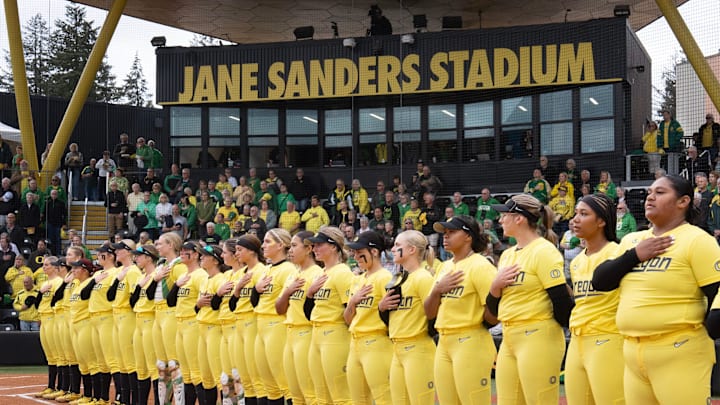 The Oregon softball team lines up for the National Anthem before their game against Michigan State at Jane Sanders Stadium.