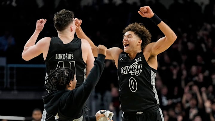 The Cincinnati Bearcats celebrate a win as time expires in the second half of the 92nd Annual Crosstown Shootout NCAA basketball game between the Cincinnati Bearcats and the Xavier Musketeers at Fifth Third Arena on the UC campus in Cincinnati on Saturday, Dec. 14, 2024. The Bearcats won 68-65.