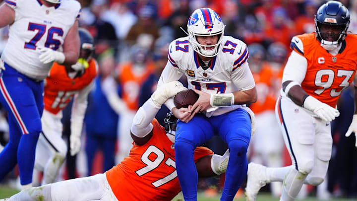 Denver Broncos defensive tackle Malcolm Roach (97) tackles Buffalo Bills quarterback Josh Allen (17) during the second quarter of an AFC Divisional Round playoff game at Empower Field at Mile High.