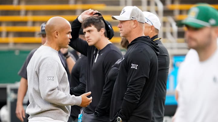 Baylor Bears head coach Dave Aranda and UCF Knights head coach Scott Frost talk at midfield prior to a game at McLane Stadium. 