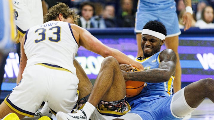 Notre Dame forward Carson Towt (33), guard Jalen Haralson, bottom, and LIU forward Mason Porter-Brown, right, fight for possession of the ball during a NCAA basketball game against LIU Brooklyn at Purcell Pavilion on Monday, Nov. 3, 2025, in South Bend.