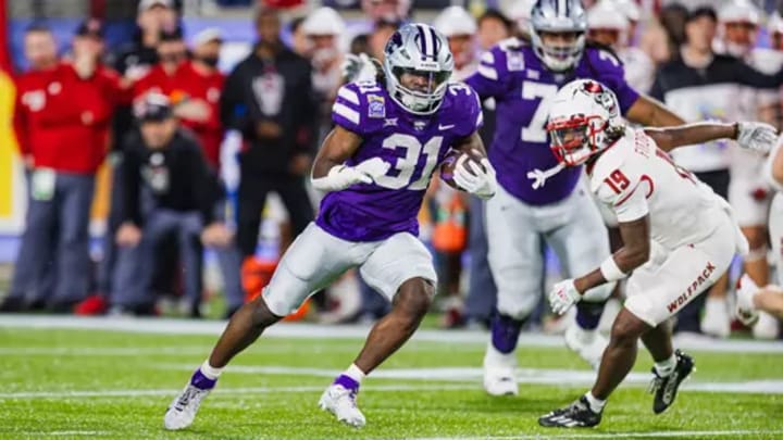 DJ Giddens (31) carries the ball in the 2023 Pop Tarts Bowl against the North Carolina State Wolfpack in Orlando, Florida on Dec. 28, 2023 at Camping World Stadium. Mandatory Credit: K-State Athletics DJ Giddens (31) carries the ball in the 2023 Pop Tarts Bowl against the North Carolina State Wolfpack in Orlando, Florida on Dec. 28, 2023 at Camping World Stadium. Mandatory Credit: K-State Athletics