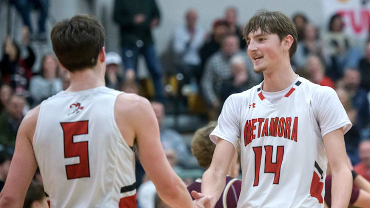 Metamora's Jonah Funk, right, congratulates teammate Matthew Zobrist on a last-second three-pointer to end the first quarter of their Mid-Illini Conference basketball game Tuesday, Feb. 18, 2025 in Metamora. The Redbirds clinched the conference title with a 59-58 win.