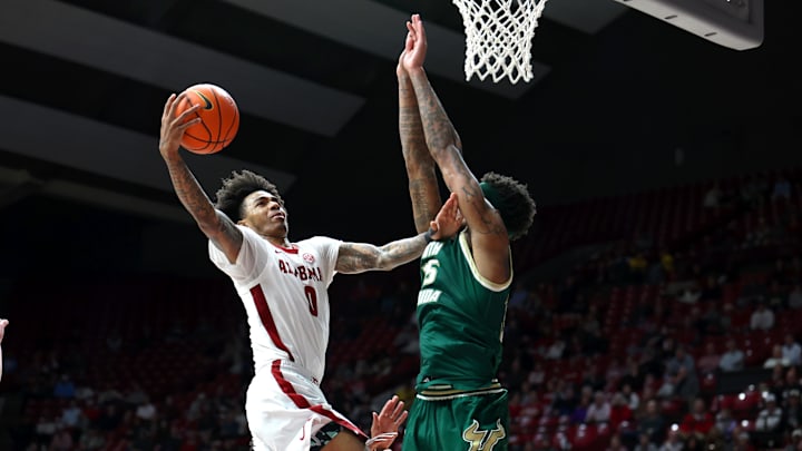 Dec 17, 2025; Tuscaloosa, Alabama, USA; Alabama Crimson Tide guard Labaron Philon (0) drives against South Florida Bulls forward Izaiyah Nelson (35) during the second half at Coleman Coliseum. Mandatory Credit: David Leong-Imagn Images