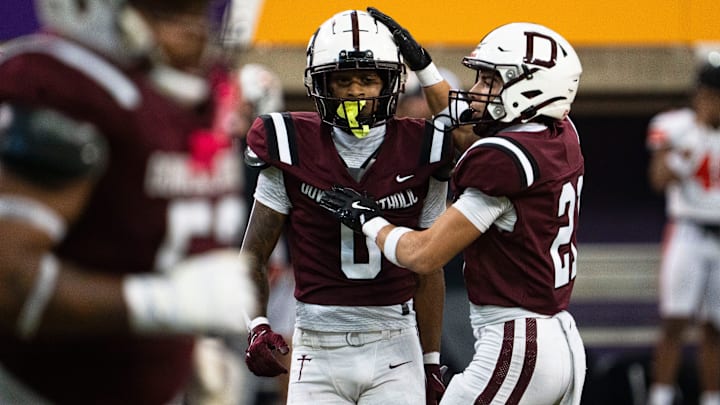 Dowling Catholic's Jordan Watson (0) and Jeremiah Roberson (21) celebrate after a stop on defense during the semifinal round of the Iowa high school football state championships at the UNI-Dome on Friday, Nov. 14, 2025, in Cedar Falls.