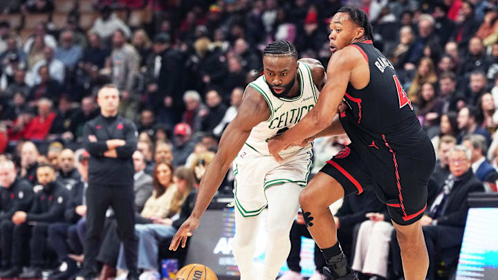 Feb 25, 2025; Toronto, Ontario, CAN; Boston Celtics guard Jaylen Brown (7) controls the ball as Toronto Raptors forward Scottie Barnes (4) tries to defend during the second quarter at the Scotiabank Arena. Mandatory Credit: Nick Turchiaro-Imagn Images