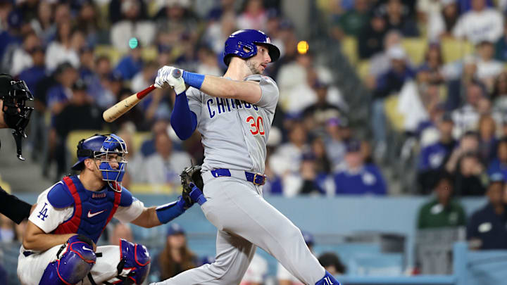 Apr 12, 2025; Los Angeles, California, USA; Chicago Cubs outfielder Kyle Tucker (30) hits a two run RBI single against the Los Angeles Dodgers during the eighth inning at Dodger Stadium. Mandatory Credit: Kiyoshi Mio-Imagn Images