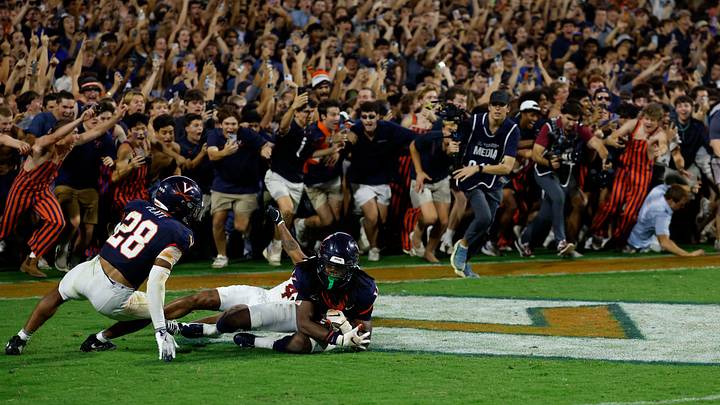 Sep 26, 2025; Charlottesville, Virginia, USA; Virginia Cavaliers defensive back Ja'son Prevard (10) is hugged by Cavaliers defensive back Donavon Platt (28) as fans storm the field after making a game winning interception in the end zone on a pass intended for Florida State Seminoles wide receiver Squirrel White (4) in the second overtime at Scott Stadium. Mandatory Credit: Geoff Burke-Imagn Images Sep 26, 2025; Charlottesville, Virginia, USA; Virginia Cavaliers defensive back Ja'son Prevard (10) is hugged by Cavaliers defensive back Donavon Platt (28) as fans storm the field after making a game winning interception in the end zone on a pass intended for Florida State Seminoles wide receiver Squirrel White (4) in the second overtime at Scott Stadium. Mandatory Credit: Geoff Burke-Imagn Images
