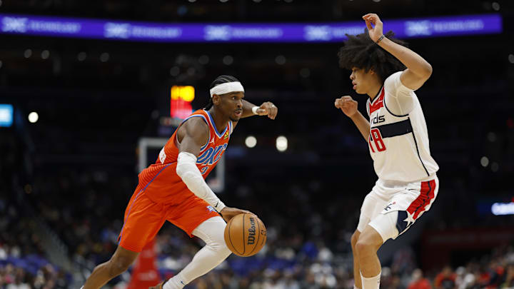 Jan 12, 2025; Washington, District of Columbia, USA; Oklahoma City Thunder guard Shai Gilgeous-Alexander (2) drives to the basket as Washington Wizards forward Kyshawn George (18) defends in the third quarter at Capital One Arena. Mandatory Credit: Geoff Burke-Imagn Images