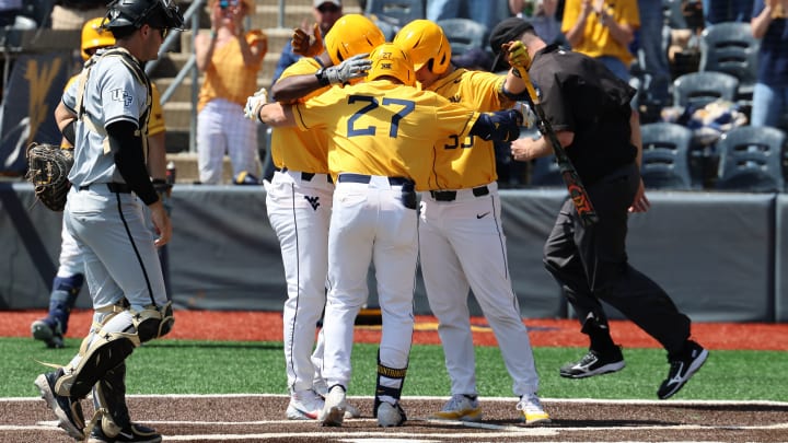 West Virginia slugger JJ Wetherholt is greeted by teammates Skylar King and Logan Suave after a two-run home run in the series finale against UCF.