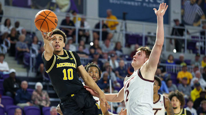 Nov 25, 2024; Fort Myers, Florida, USA; Michigan Wolverines guard Justin Pippen (10) drives to the hoop against the Virginia Tech Hokies in the first half at Suncoast Credit Union Arena. Mandatory Credit: Nathan Ray Seebeck-Imagn Images