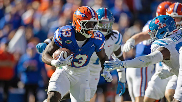 Nov 23, 2024; Gainesville, Florida, USA; Florida Gators running back Jadan Baugh (13) rushes with the ball against the Mississippi Rebels during the second half at Ben Hill Griffin Stadium. Mandatory Credit: Matt Pendleton-Imagn Images