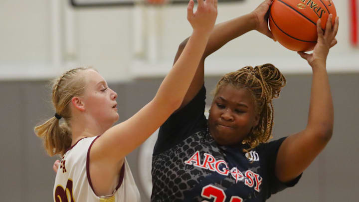 Argosy Collegiate Charter's Vynnom Devoe tries to make a pass under pressure from Bristol Aggie's Abigail Krzyszton during an MIAA-MCSAO crossover game on Dec. 13, 2024.