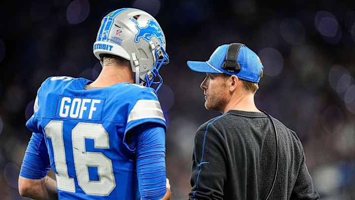 Detroit Lions quarterback Jared Goff (16), left, talks to offensive coordinator Ben Johnson before a play against Chicago Bears during the first half at Ford Field in Detroit on Thursday, Nov. 28, 2024.