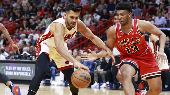 Feb 28, 2022; Miami, Florida, USA;  Miami Heat center Omar Yurtseven (77) and Chicago Bulls forward Tony Bradley (13) fight for a loose ball during the second half at FTX Arena. Mandatory Credit: Rhona Wise-Imagn Images