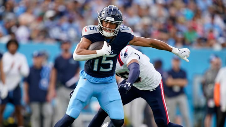 Tennessee Titans wide receiver Nick Westbrook-Ikhine (15) slips away from New England Patriots safety Marte Mapu (15) for a first down in the third quarter at Nissan Stadium in Nashville, Tenn., Sunday, Nov. 3, 2024.
