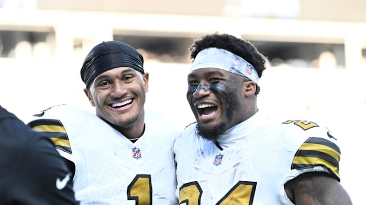 Nov 9, 2025; Charlotte, North Carolina, USA; New Orleans Saints cornerback Alontae Taylor (1) and running back Devin Neal (24) react after the game at Bank of America Stadium. Mandatory Credit: Bob Donnan-Imagn Images