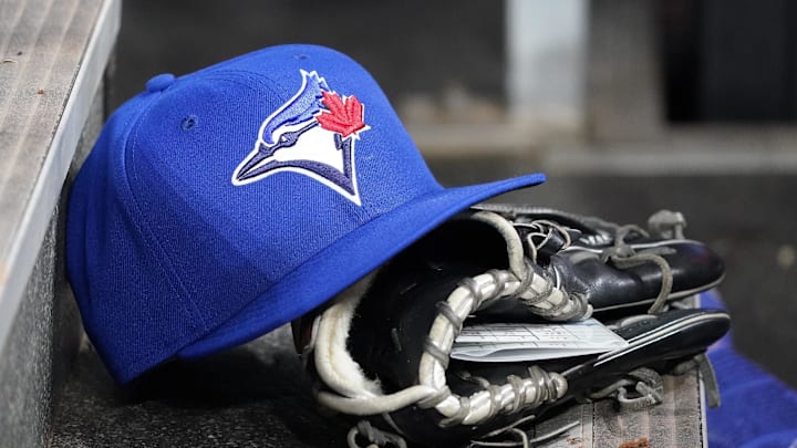 Apr 16, 2025; Toronto, Ontario, CAN; A Toronto Blue Jays hat and glove in the dugout during a game against the Atlanta Braves at Rogers Centre. 