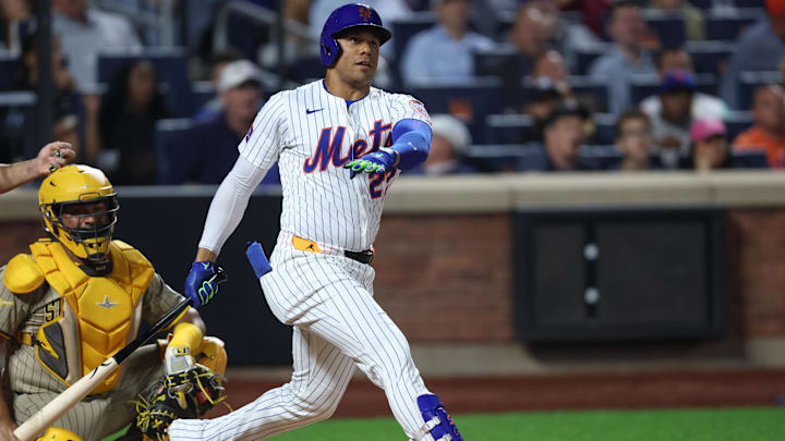 Sep 17, 2025; New York City, New York, USA; New York Mets right fielder Juan Soto (22) hits a home run during the fifth inning against the San Diego Padres at Citi Field. Mandatory Credit: Vincent Carchietta-Imagn Images