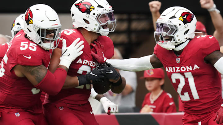 Arizona Cardinals linebacker Zaven Collins (25) celebrates his touchdown on a recovered fumble with teammates Garrett Williams (21) and Dante Stills (55) during their game against the Carolina Panthers at State Farm Stadium on Sept. 14, 2025.