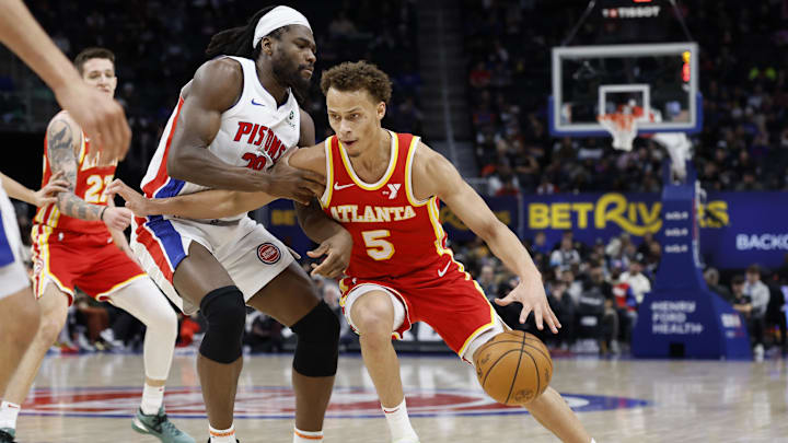 Feb 3, 2025; Detroit, Michigan, USA;  Atlanta Hawks guard Dyson Daniels (5) dribbles defended by Detroit Pistons center Isaiah Stewart (28) in the second half at Little Caesars Arena. Mandatory Credit: Rick Osentoski-Imagn Images