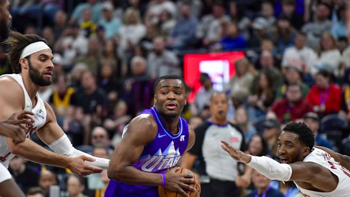 Mar 23, 2025; Salt Lake City, Utah, USA; Utah Jazz guard Isaiah Collier (13) makes drive against Cleveland Cavaliers guard Donovan Mitchell (45) during the first half at Delta Center. Mandatory Credit: Peter Creveling-Imagn Images